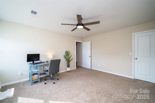 carpeted home office with a ceiling fan, visible vents, and baseboards