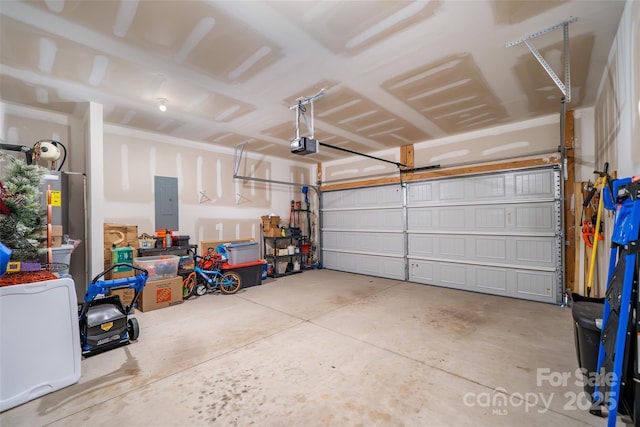 garage featuring electric panel and a garage door opener