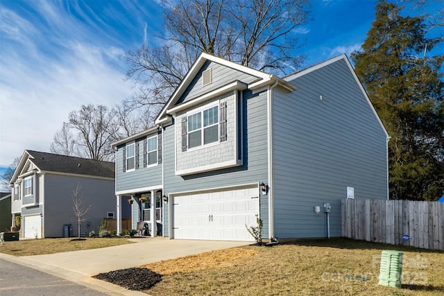 view of front of house featuring a garage, driveway, and fence