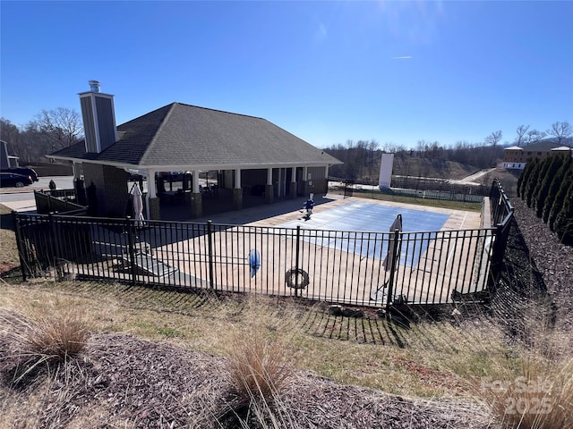 community pool featuring a patio area and fence