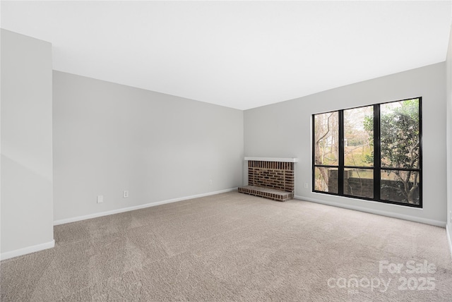 unfurnished living room featuring baseboards and carpet floors