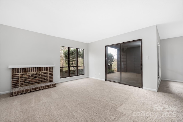 unfurnished living room featuring baseboards and carpet