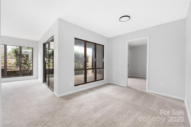 empty room with baseboards and carpet flooring