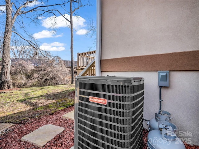 details featuring central air condition unit and stucco siding