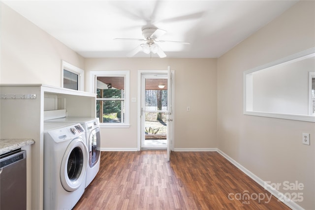 washroom with washing machine and clothes dryer, a ceiling fan, wood finished floors, laundry area, and baseboards