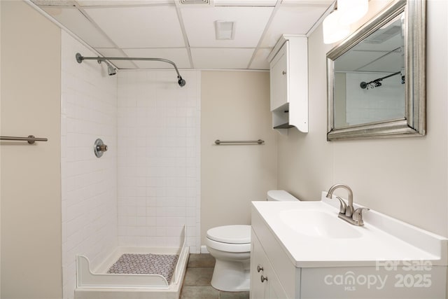 bathroom featuring a drop ceiling, toilet, visible vents, vanity, and a shower stall