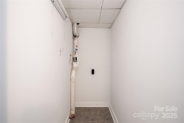 laundry area featuring laundry area, baseboards, and tile patterned floors