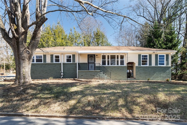 ranch-style house with brick siding and a front lawn