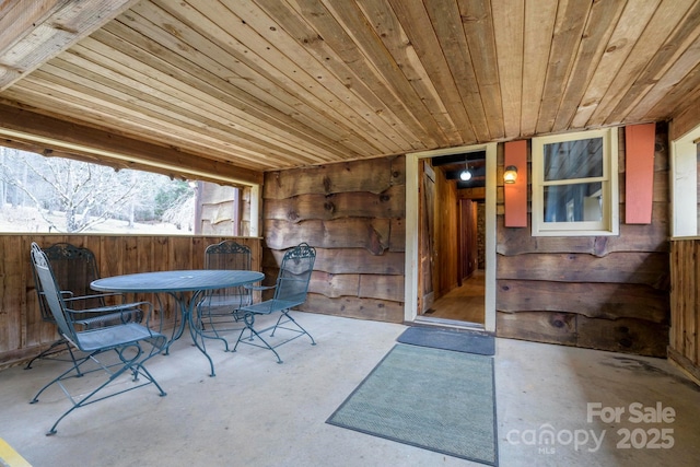 view of patio with outdoor dining space and fence