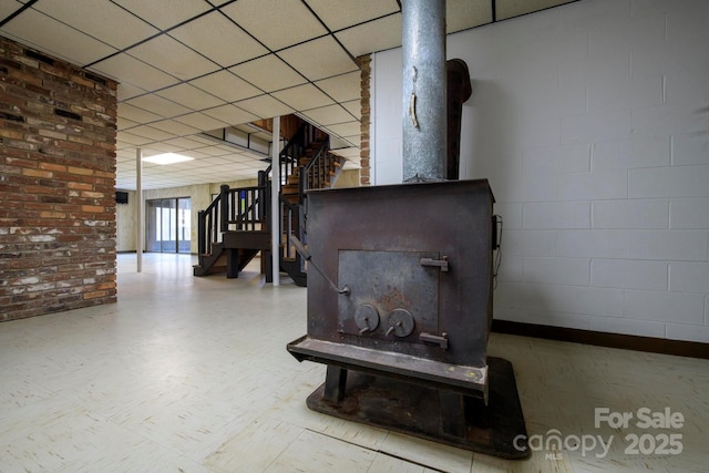 interior space with a drop ceiling and tile patterned floors