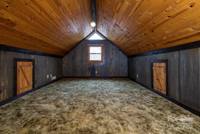 bonus room with wooden ceiling, vaulted ceiling, wood walls, and dark colored carpet