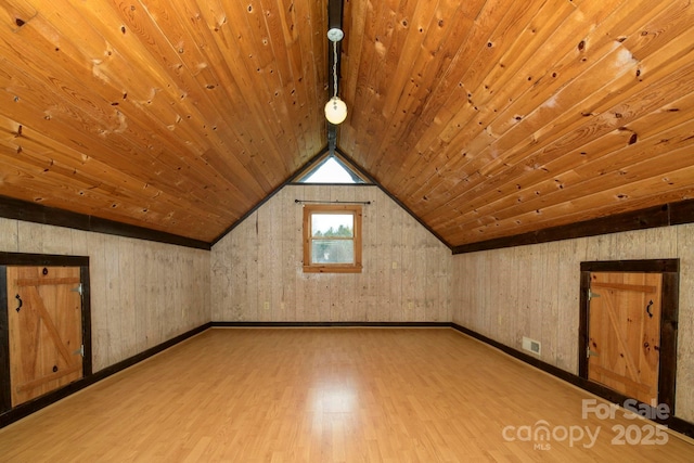 additional living space with light wood-type flooring, wood ceiling, visible vents, and lofted ceiling