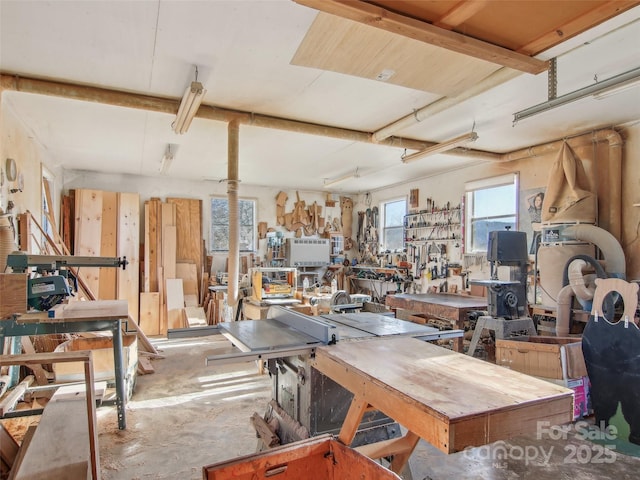 misc room featuring a workshop area and concrete flooring