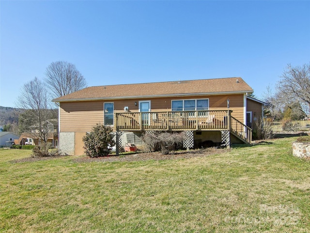 back of house with a wooden deck and a lawn