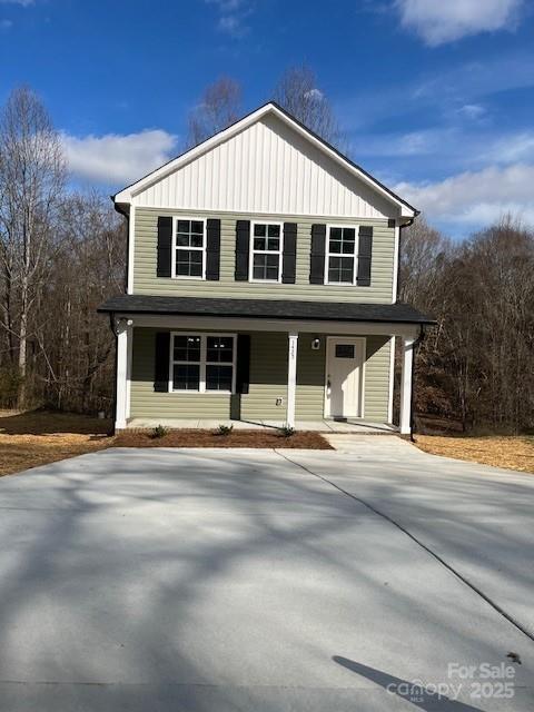 view of front of house with board and batten siding and concrete driveway