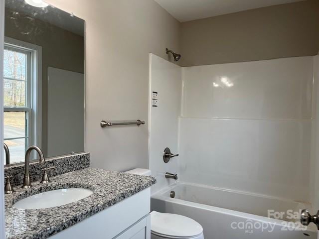 bathroom featuring shower / bath combination, vanity, and toilet