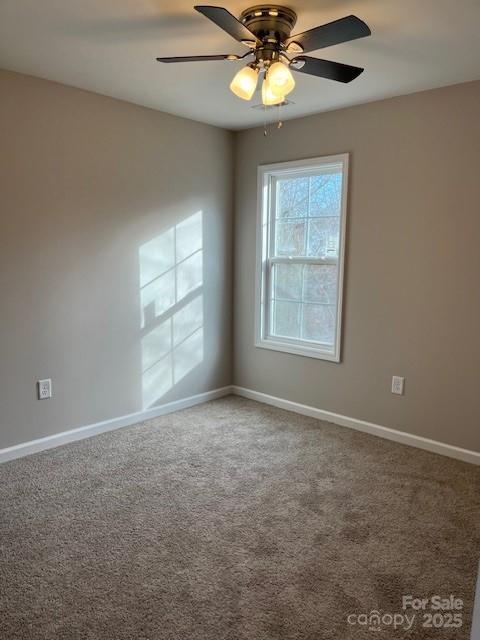 unfurnished room with ceiling fan, carpet flooring, and baseboards