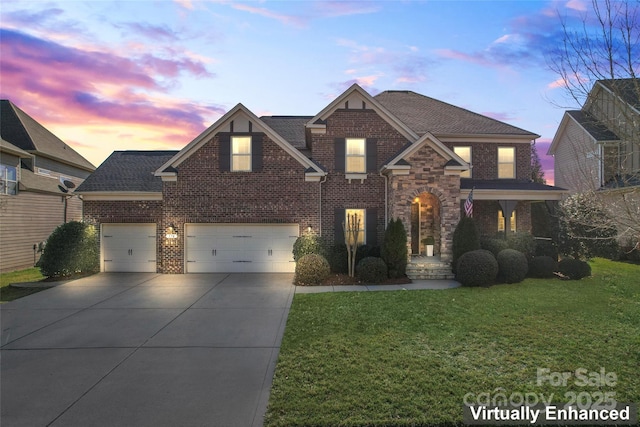 view of front of house with concrete driveway, roof with shingles, an attached garage, a front lawn, and brick siding