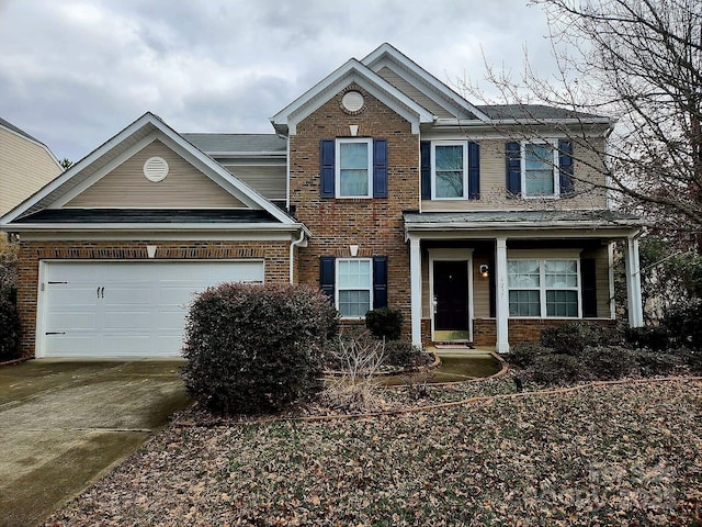 traditional home featuring driveway, brick siding, and an attached garage