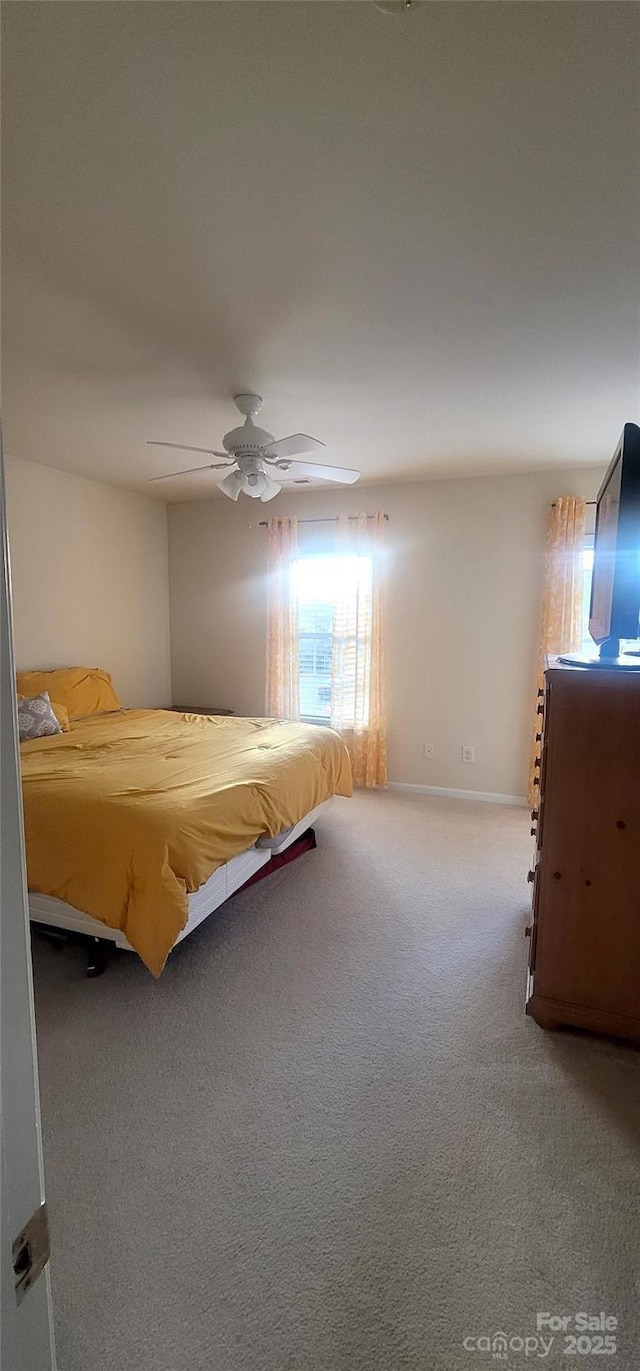 unfurnished bedroom featuring a ceiling fan, carpet, and baseboards