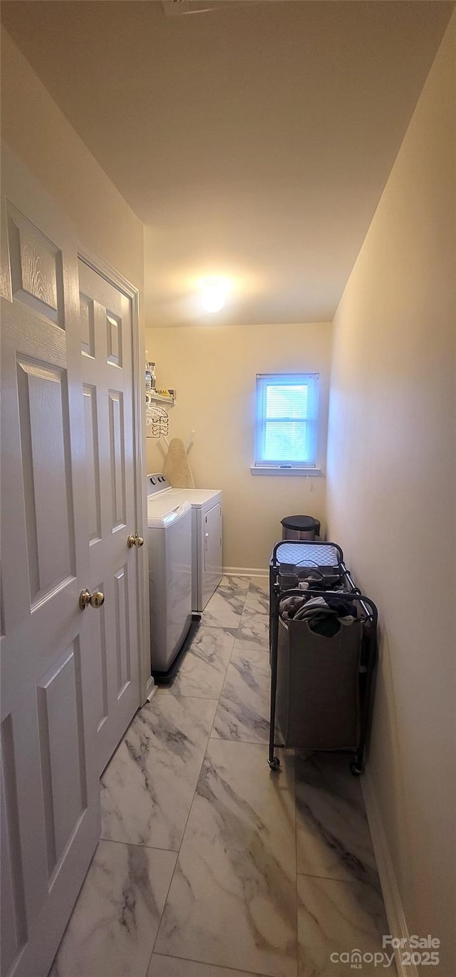 laundry room featuring marble finish floor, independent washer and dryer, laundry area, and baseboards