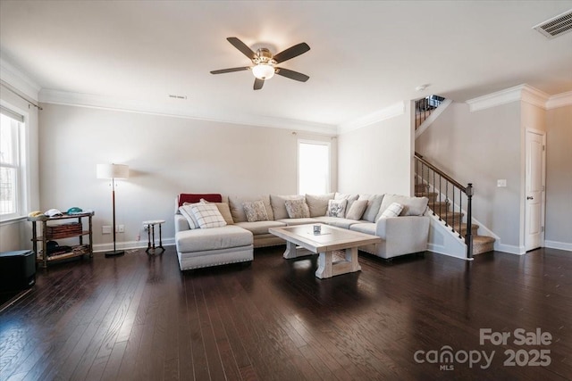 living room with baseboards, visible vents, hardwood / wood-style flooring, ornamental molding, and stairs