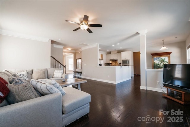 living area with recessed lighting, dark wood-type flooring, a ceiling fan, baseboards, and crown molding