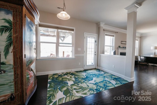 entryway with decorative columns, visible vents, baseboards, wood-type flooring, and ornamental molding