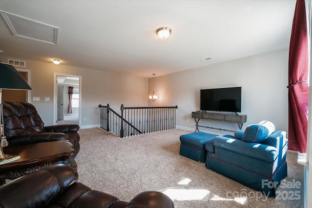 carpeted living area featuring visible vents and baseboards