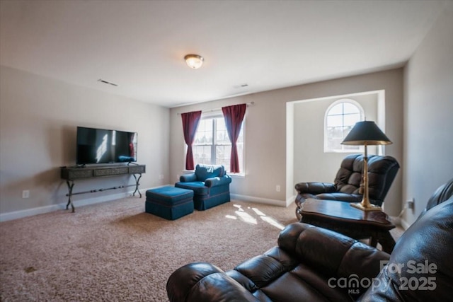 carpeted living room featuring visible vents and baseboards