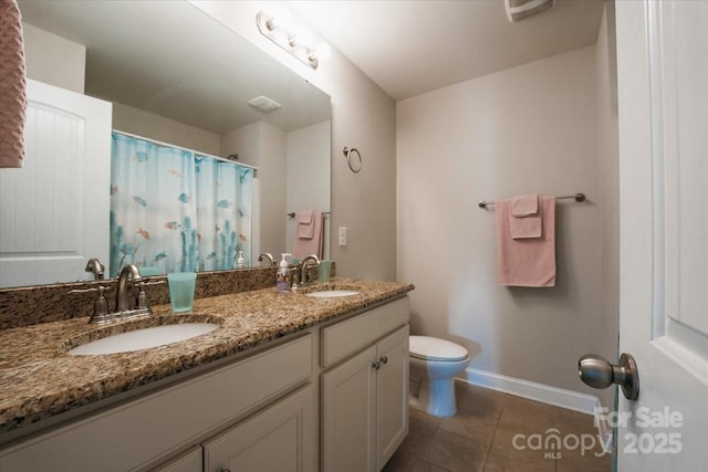 full bath with toilet, tile patterned flooring, baseboards, and a sink