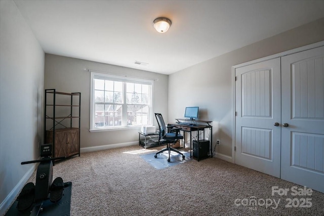 carpeted office space featuring visible vents and baseboards