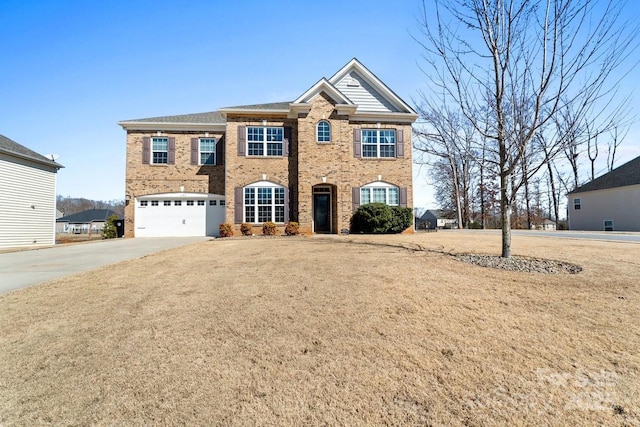 view of front of house featuring driveway, brick siding, a front lawn, and an attached garage