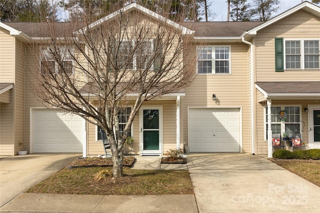 townhome / multi-family property with a garage and concrete driveway