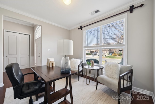 home office featuring baseboards, visible vents, crown molding, and wood finished floors