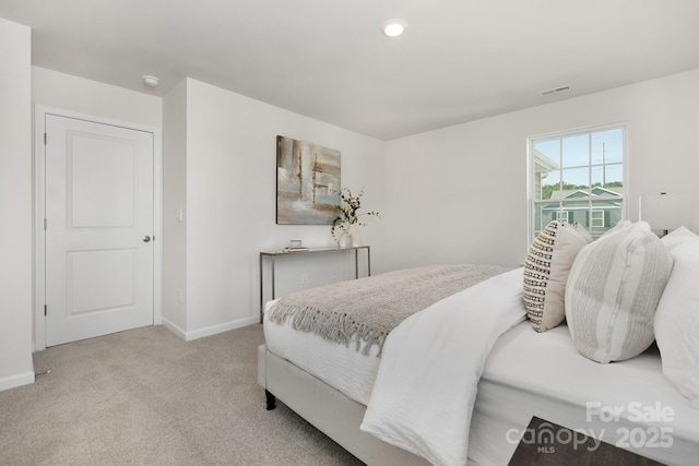 bedroom featuring light colored carpet