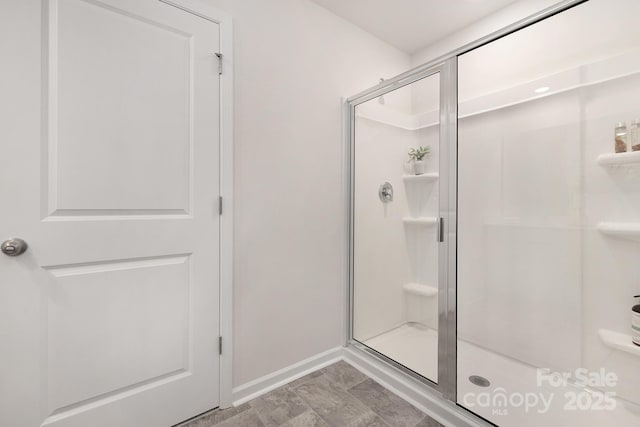 bathroom with a shower with door