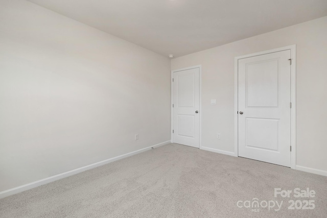 unfurnished bedroom featuring light carpet