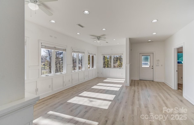 interior space featuring a ceiling fan and visible vents