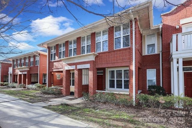 view of property featuring brick siding