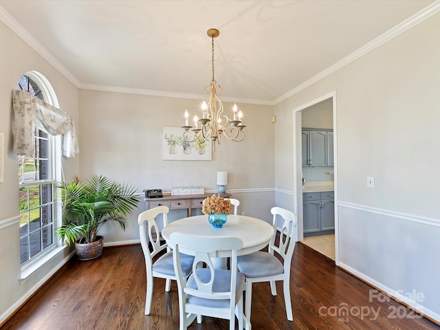 dining space with ornamental molding, dark wood-style flooring, and baseboards