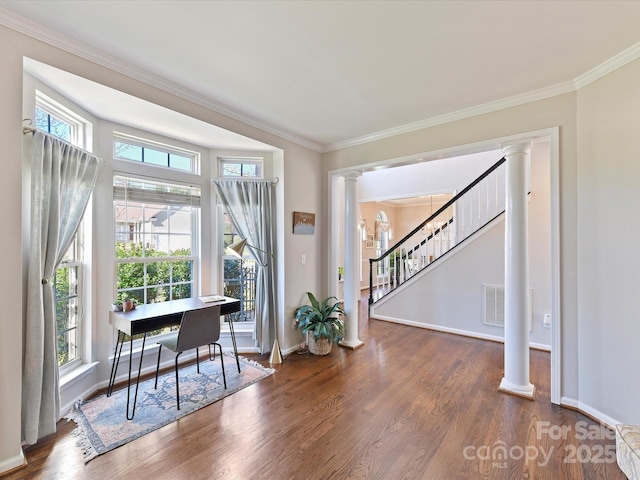 interior space with dark wood-style floors, stairway, decorative columns, and crown molding