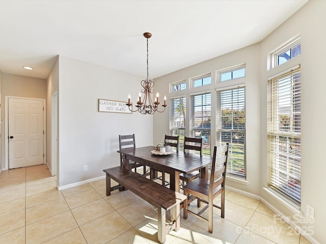 dining room with an inviting chandelier, baseboards, and light tile patterned flooring