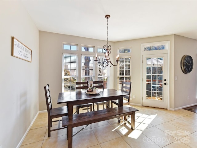 dining room featuring a chandelier, baseboards, and light tile patterned floors