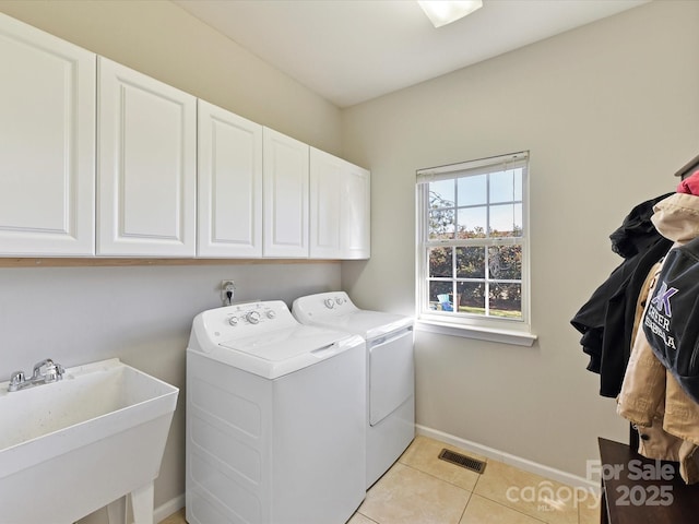 laundry area featuring cabinet space, visible vents, baseboards, washer and dryer, and a sink