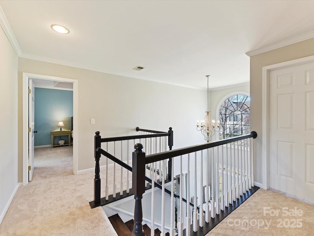 hallway with crown molding, carpet floors, an upstairs landing, and baseboards