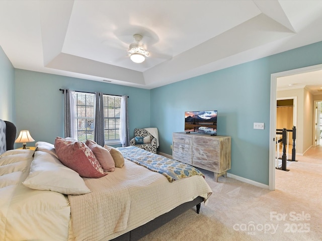 bedroom featuring a raised ceiling, visible vents, light carpet, ceiling fan, and baseboards