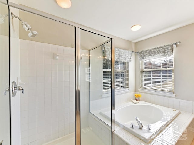 bathroom featuring a stall shower and a garden tub