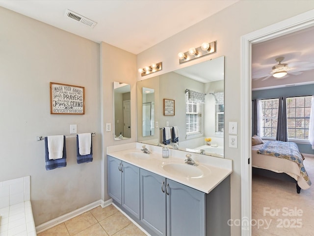 bathroom with tile patterned floors, visible vents, a sink, and ensuite bathroom