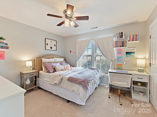 bedroom featuring a ceiling fan, light colored carpet, visible vents, and baseboards